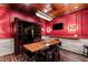 A cozy wine cellar featuring a rustic table, custom cabinetry, and a relaxed atmosphere for wine enthusiasts at 12132 Lockhart Ln, Raleigh, NC 27614