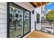 Private balcony with wood floor overlooks exterior and is separated by a large sliding glass door for indoor/outdoor living at 1249 S Blount Street # 101, Raleigh, NC 27601