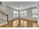 Bright living space featuring hardwood flooring, staircase and multiple windows at 1249 S Blount Street # 101, Raleigh, NC 27601