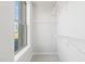 Bright walk-in closet with wire shelving and a view from the window at 1249 S Blount Street # 101, Raleigh, NC 27601