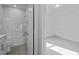 Bathroom with toilet, tub, and shower combination next to a bedroom space at 1254 White Flint Cir, Durham, NC 27703