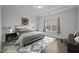 Bedroom features tray ceiling, hardwood floors, and a window overlooking the yard at 1254 White Flint Cir, Durham, NC 27703