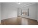 Bedroom with hardwood floors, crown molding, and a large window letting in natural light at 1254 White Flint Cir, Durham, NC 27703