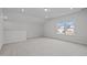 Unfurnished bonus room showcasing carpeted floor, neutral walls, and bright window view at 1254 White Flint Cir, Durham, NC 27703