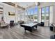 Bright clubhouse featuring a billiards table, comfortable seating, a fireplace, and large windows with outdoor views at 1254 White Flint Cir, Durham, NC 27703