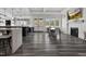 A wide view of the clubhouse featuring a kitchen, dining area, and fireplace, all connected by elegant flooring at 1254 White Flint Cir, Durham, NC 27703