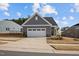 Quaint single-story home with a gray exterior, well-kept lawn, and a convenient two-car garage at 1254 White Flint Cir, Durham, NC 27703