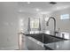 Close up of kitchen with stainless steel sink, stainless steel appliances, countertop, and natural lighting at 1254 White Flint Cir, Durham, NC 27703