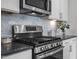 Modern kitchen features stainless steel appliances, including a microwave and gas range at 1254 White Flint Cir, Durham, NC 27703