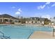 A large community pool with sun loungers and seating areas for residents to enjoy at 1254 White Flint Cir, Durham, NC 27703