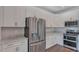 Contemporary kitchen with stainless steel fridge, oven, white cabinets and granite countertops at 1257 S Blount Street # 101, Raleigh, NC 27601