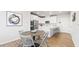 Modern kitchen with white cabinetry, stainless steel appliances, and a breakfast bar at 1257 S Blount Street # 101, Raleigh, NC 27601