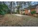 Brick home exterior with spacious backyard and mature trees, offering a private outdoor space at 127 Wilkinson St, Rocky Mount, NC 27804