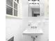 A classic bathroom with vintage sink, all-white tile, and black and white tile floor at 127 Wilkinson St, Rocky Mount, NC 27804