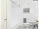 Classic white bathroom featuring vintage tile floor, tub with shower, and fixtures at 127 Wilkinson St, Rocky Mount, NC 27804