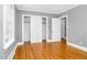 Comfortable bedroom with hardwood floors, closet, and two entry doors at 127 Wilkinson St, Rocky Mount, NC 27804