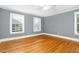 A serene bedroom featuring hardwood floors, neutral walls, and double-hung windows at 127 Wilkinson St, Rocky Mount, NC 27804