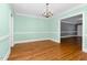 Inviting dining room with hardwood floors, chandelier, mint walls, and white wainscoting at 127 Wilkinson St, Rocky Mount, NC 27804