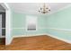 Bright dining room featuring hardwood floors, natural light, and a stylish chandelier at 127 Wilkinson St, Rocky Mount, NC 27804