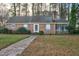 Charming single-story brick home with a brick walkway, inviting curb appeal, and mature trees at 127 Wilkinson St, Rocky Mount, NC 27804