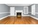 Spacious living room with hardwood floors, fireplace, white molding, and abundant natural light at 127 Wilkinson St, Rocky Mount, NC 27804