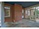 Enclosed porch showcasing brick wall, slate flooring, and access to the home's exterior at 127 Wilkinson St, Rocky Mount, NC 27804
