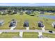Aerial view showcases homes in a well-maintained community with expansive grassy yards and a tranquil pond at 147 Young Farm Dr, Lillington, NC 27546