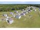 Aerial view showcases homes in a well-maintained community with expansive grassy yards, garages, and driveways at 147 Young Farm Dr, Lillington, NC 27546