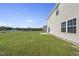 Well-maintained backyard featuring green grass and privacy with a glimpse of the community pond at 147 Young Farm Dr, Lillington, NC 27546