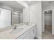 Bathroom featuring double vanity, large mirrors, white cabinets and a separate walk-in shower at 147 Young Farm Dr, Lillington, NC 27546