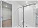 Modern bathroom featuring a glass-enclosed shower with built-in bench and adjacent closet with wire shelving at 147 Young Farm Dr, Lillington, NC 27546
