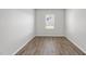 A bright bedroom is filled with hardwood floors and a single window that lets in natural light at 147 Young Farm Dr, Lillington, NC 27546