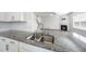 Close-up on a kitchen featuring granite counters and stainless steel sink at 147 Young Farm Dr, Lillington, NC 27546