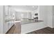 Kitchen boasts granite counters, white cabinets, and modern appliances in an open-concept layout at 147 Young Farm Dr, Lillington, NC 27546