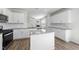 Open kitchen with island, stainless steel appliances, and a view of the living area with fireplace at 147 Young Farm Dr, Lillington, NC 27546