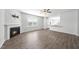 Open-concept living space flows into the kitchen, featuring hardwood floors and a cozy fireplace at 147 Young Farm Dr, Lillington, NC 27546