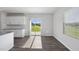 Bright living area adjacent to kitchen with sliding glass door and window offering natural light at 147 Young Farm Dr, Lillington, NC 27546