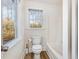 Bright bathroom with a window, toilet, and bathtub at 1532 Rockwood Downs Dr, Wendell, NC 27591