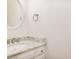 Clean half-bath with granite counter, white sink, and decorative round mirror at 1532 Rockwood Downs Dr, Wendell, NC 27591