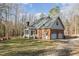 Exterior view of a brick two-story home featuring an attached garage and sun room at 1532 Rockwood Downs Dr, Wendell, NC 27591