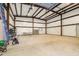 Spacious metal outbuilding interior with concrete floor and equipment at 1532 Rockwood Downs Dr, Wendell, NC 27591