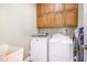 Functional laundry room with modern washer, dryer, and plenty of storage cabinets at 1532 Rockwood Downs Dr, Wendell, NC 27591
