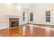 Bright living room features hardwood floors, fireplace, and large windows at 1532 Rockwood Downs Dr, Wendell, NC 27591