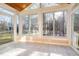 Bright sun room with wood ceiling and large windows providing forest views at 1532 Rockwood Downs Dr, Wendell, NC 27591