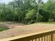 View of a wooded backyard showing the topsoil prepped for landscaping at 162 Kirkwall Ln, Selma, NC 27576