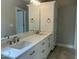 A stylish bathroom showcasing a double sink vanity with ample storage, illuminated by a decorative light fixture at 162 Kirkwall Ln, Selma, NC 27576