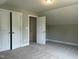 A cozy bedroom featuring plush carpet and direct closet access, offering comfort and convenience in a personal space at 162 Kirkwall Ln, Selma, NC 27576