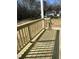 New wood deck with fresh stain overlooks a partially wooded lot at 162 Kirkwall Ln, Selma, NC 27576