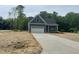 Charming home with a large driveway, attached garage, and beautifully contrasting trim and siding at 162 Kirkwall Ln, Selma, NC 27576