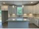 Beautiful kitchen with sleek countertops, stainless steel appliances, white cabinets, and an island with pendant lights at 162 Kirkwall Ln, Selma, NC 27576